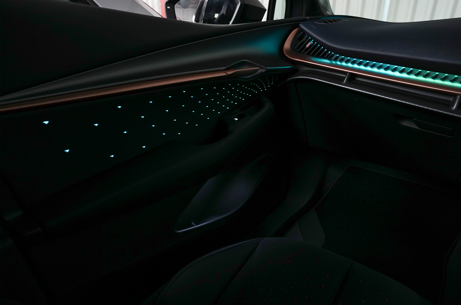 Interior shot of the CUPRA Tavascan showing aquamarine ambient lighting