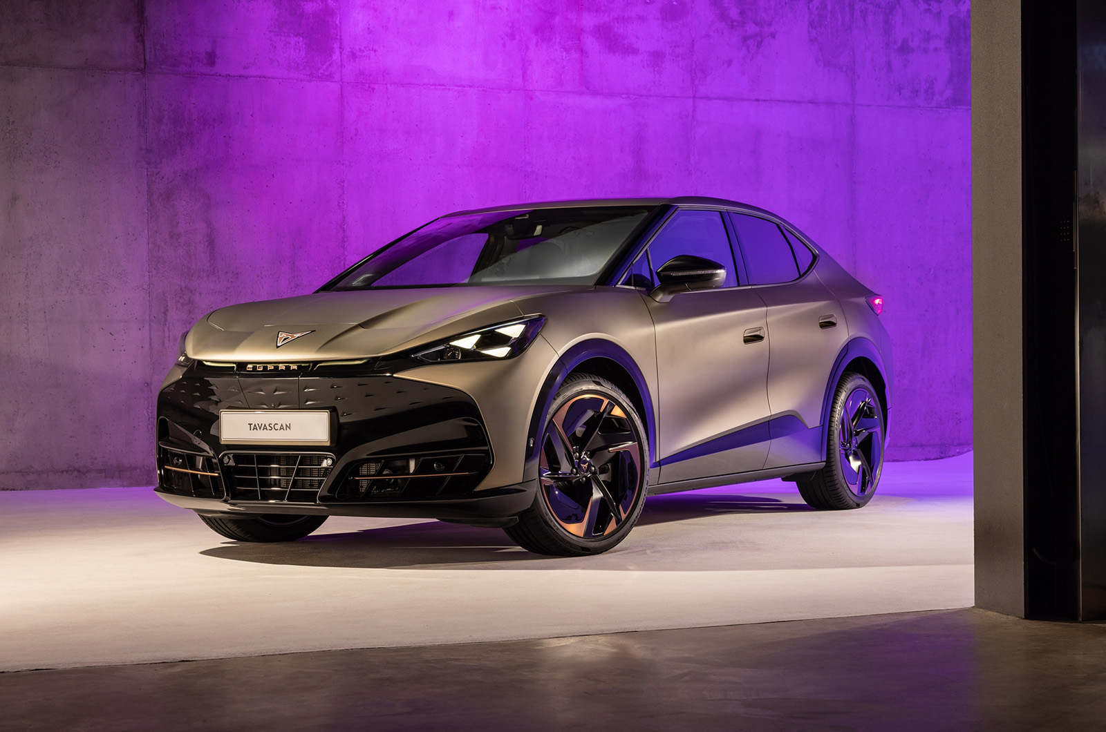 Front three-quarter exterior shot of a Century Bronze CUPRA Tavascan in a studio