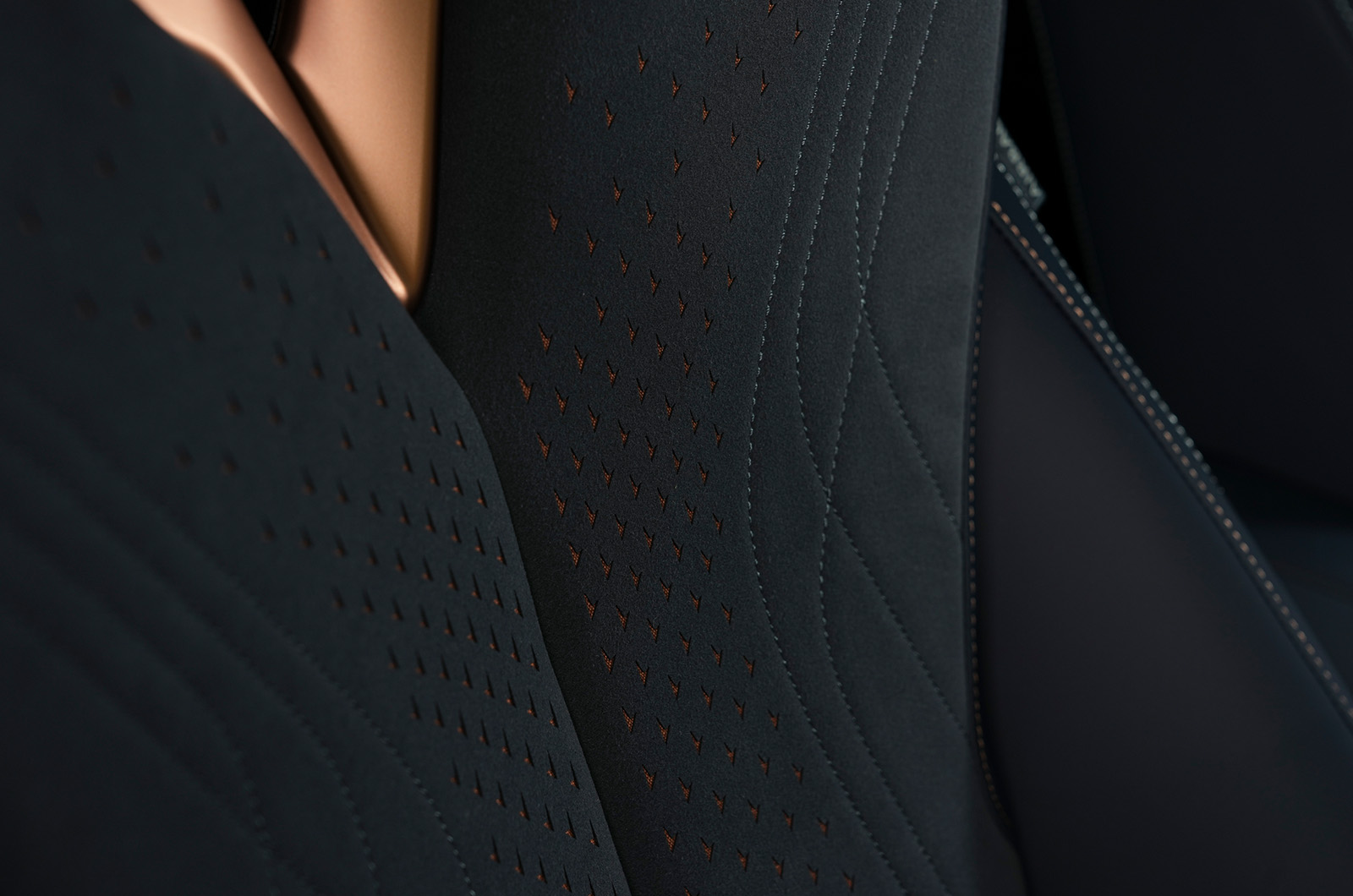 Detail shot of the bronze stitching and detailing in the CUPRA Tavascan bucket seats