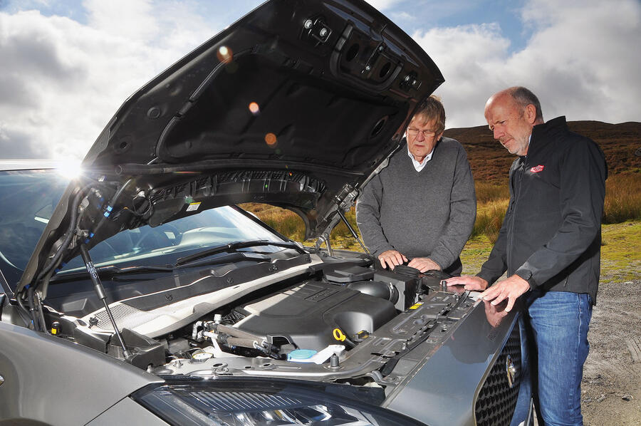 Jaguar e pace inspecting the engine