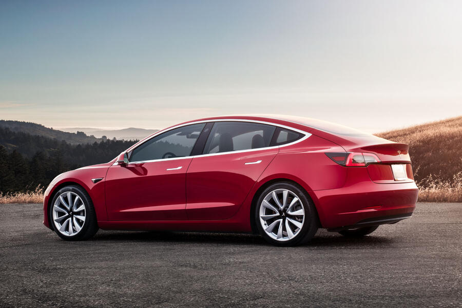 Model 3 red rear sunset