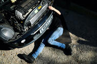 Person under car repairs Getty Images