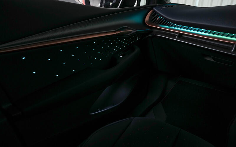 Interior shot of the CUPRA Tavascan showing aquamarine ambient lighting