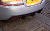 Rear diffuser is made from carbonfibre. The aero work continues out of sight under the car Aston Martin DBS rear diffuser