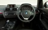 Glossy black fascia trim with red accents lifts the otherwise conservative cabin BMW 1 Series interior