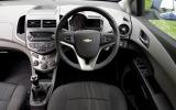 The heavily sculpted steering wheel features switches for the stereo and cruise control Chevrolet Aveo dashboard