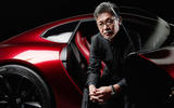 Ikuo Maeda with concept car Ikuo Maeda with concept car