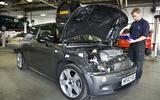 Dealer working on car Mini Cooper Dealer working on car Mini Cooper