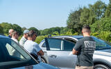 People looking at cars