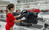 Ferrari E Building factory   worker fitting steering wheel