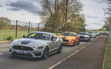 Grey Ford Mustang leading more mustangs