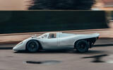 Porsche 917 driving on street side tracking Porsche 917 driving on street side tracking
