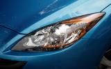 Headlights look overdone. Oddly the amber strip is not the indicator; there is an exposed amber bulb for that Mazda 3 xenon headlights