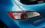 Tail-lights look like something from an accessory shop, with their clear lenses, glinting circles within and the splashes of red Mazda 3 rear lights