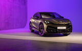 Front three-quarter exterior static shot of a grey Cupra Tavascan in a studio with purple lighting in the background