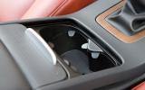 Front centre armrest contains spacious storage box; cupholders sit in front, under neat sliding lid.  Volvo V70 cupholders