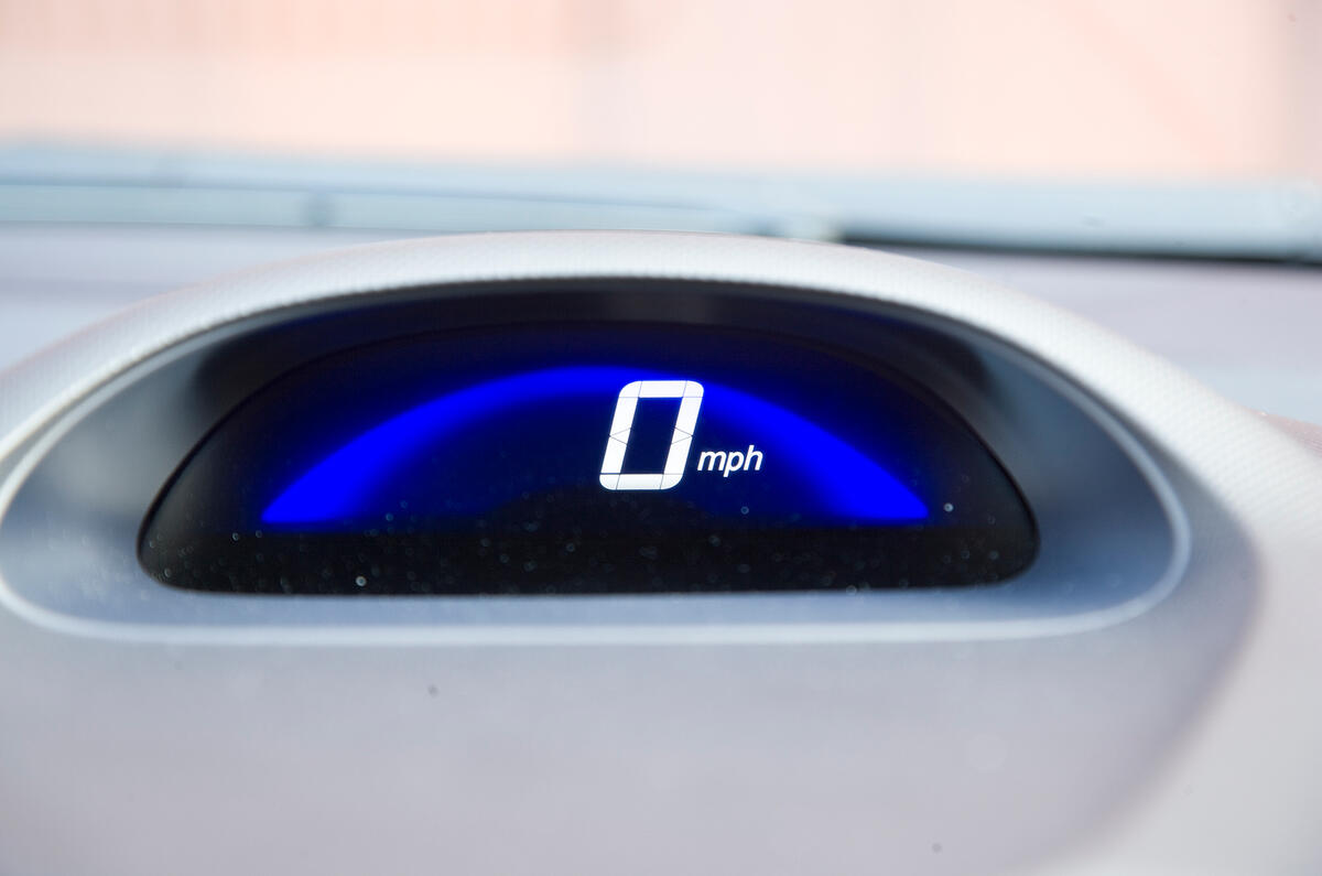 Background of digital speed readout changes colour depending on how you are driving: green for efficient, blue for lead foot.  Honda Insight speedometer