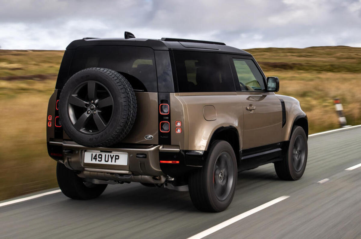 Land Rover Defender 90 on the road rear Land Rover Defender 90 on the road rear