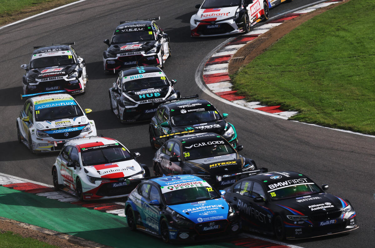 A tight pack of BTCC cars cornering A tight pack of BTCC cars cornering