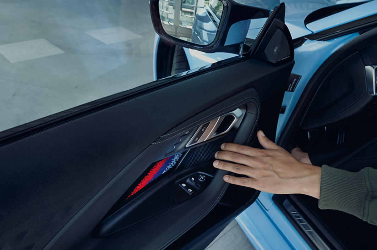Bold BMW M colours in the door panel enhance the BMW M2's race-inspired character