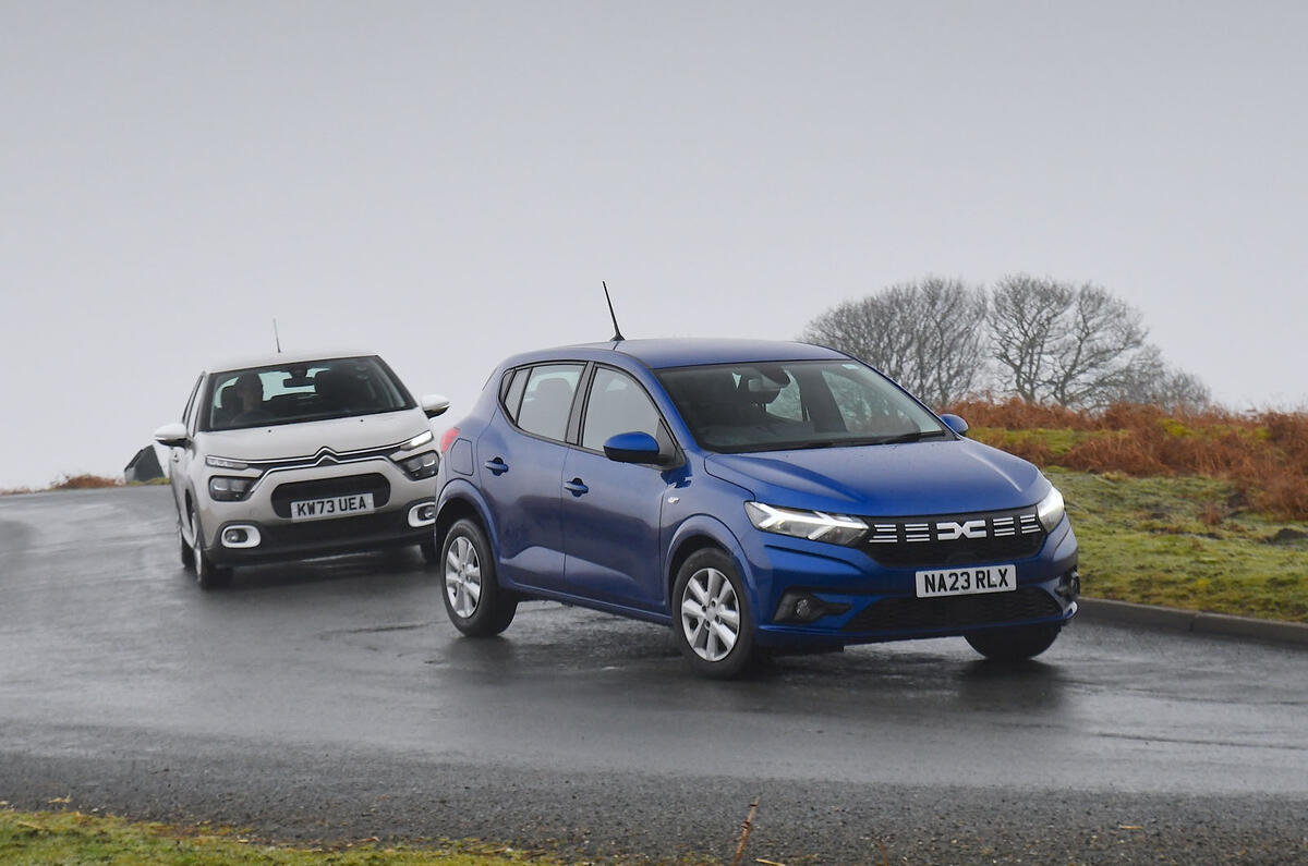Blue Dacia Sandero and grey Citroen C3 cornering