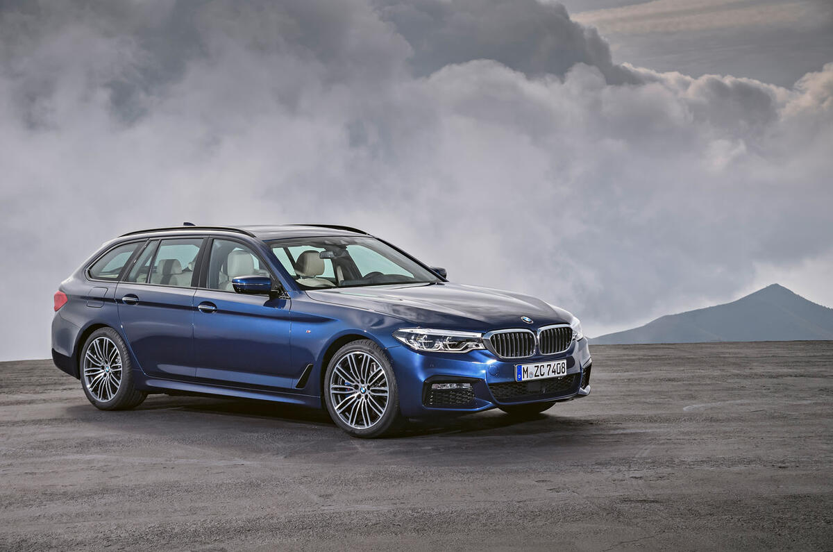 2017 BMW 5 Series Touring in front of mountains
