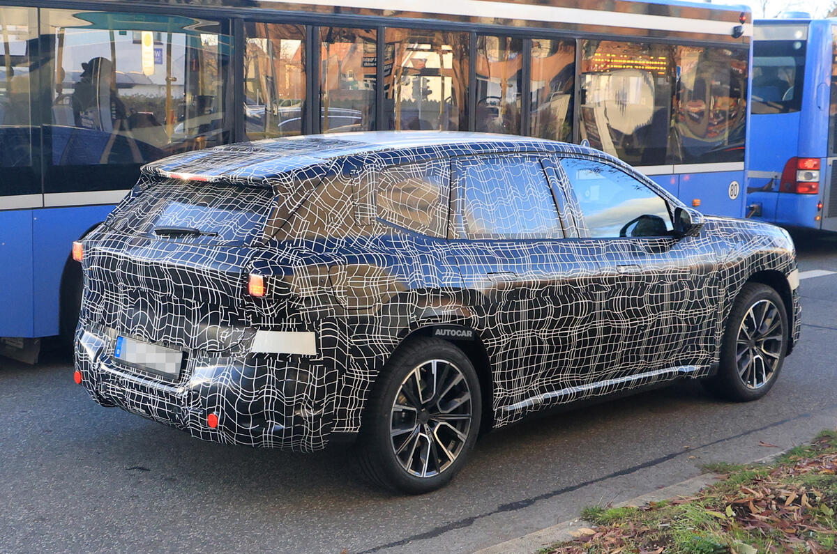 BMW Neue Klasse SUV side rear in traffic BMW Neue Klasse SUV side rear in traffic