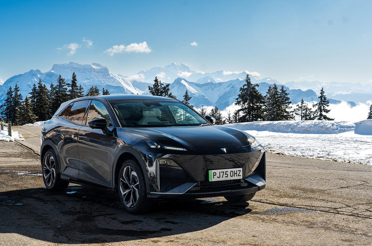 A black Changan Deepal S07 with the Alps in the background