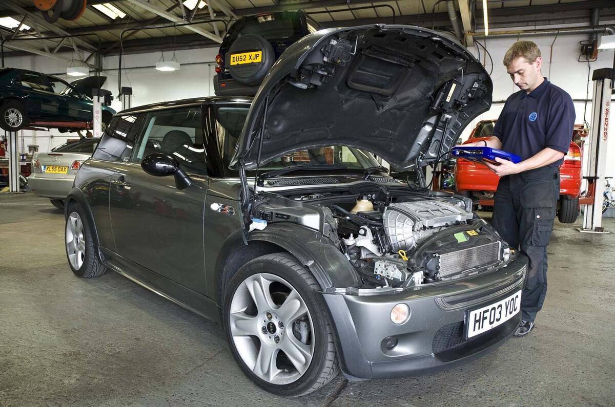 Dealer working on car Mini Cooper Dealer working on car Mini Cooper