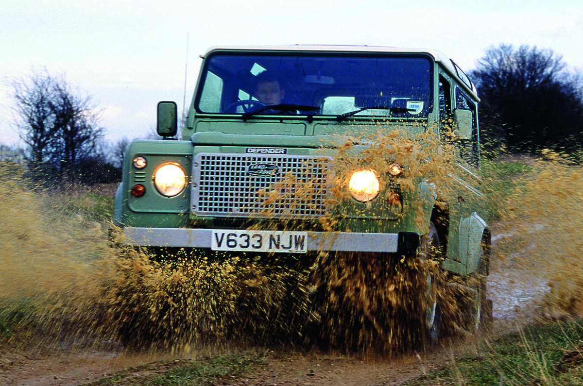 Land Rover Defender driving through mud