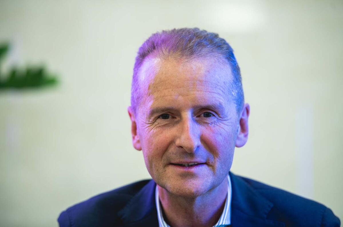 Volkswagen boss Herbert Diess talks to Autocar