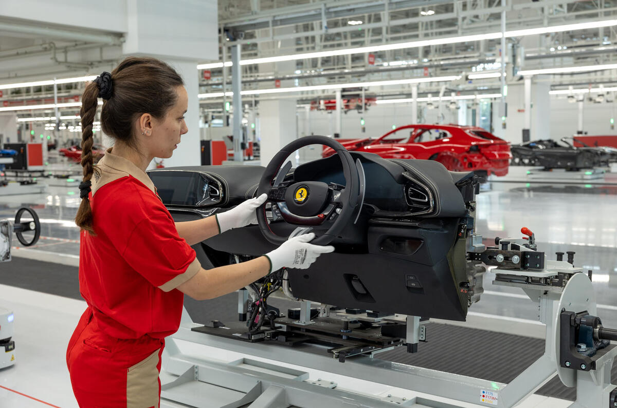 Ferrari E Building factory   worker fitting steering wheel Ferrari E Building factory   worker fitting steering wheel