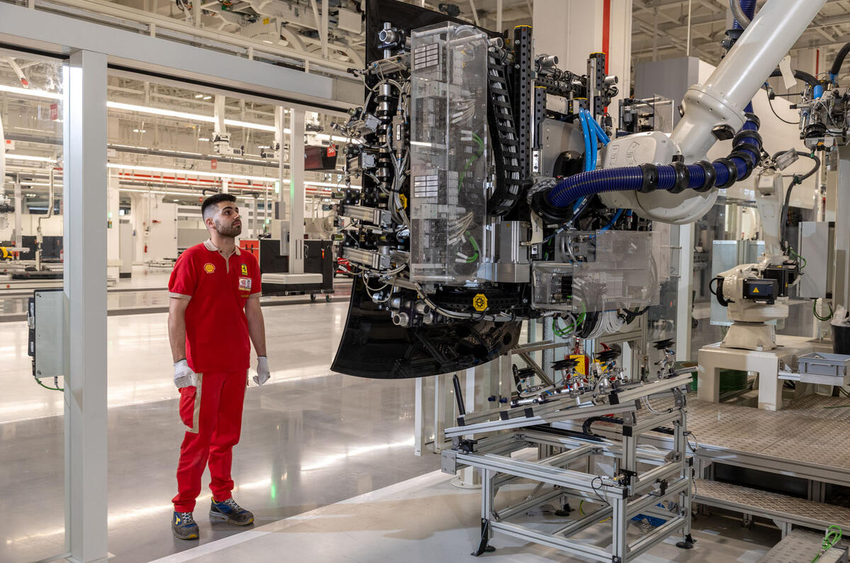 Ferrari E Building factory   worker inspects a screen Ferrari E Building factory   worker inspects a screen