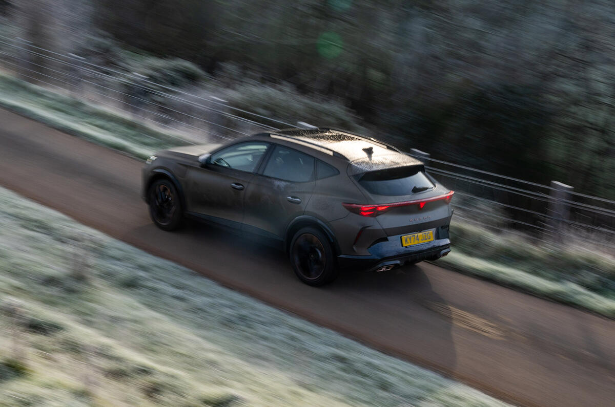A CUPRA Formentor e-HYBRID driving on a country road viewed form above