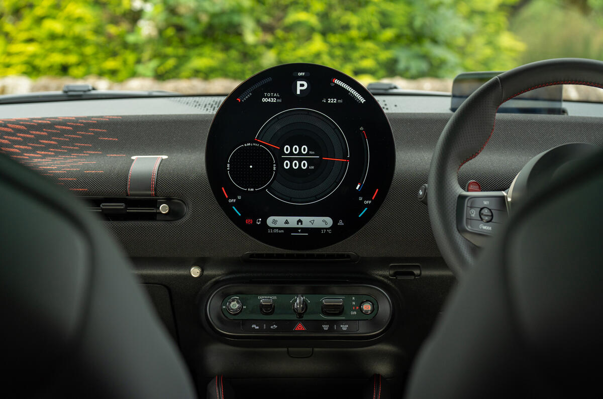 MINI Aceman JCW interior shot focusing on the circular OLED infotainment screen