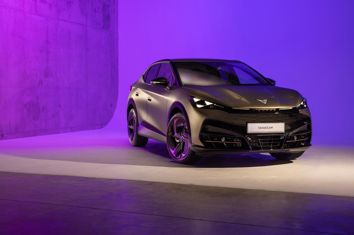 Front three-quarter exterior static shot of a grey Cupra Tavascan in a studio with purple lighting in the background