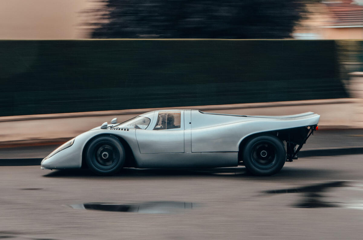 Porsche 917 driving on street side tracking Porsche 917 driving on street side tracking