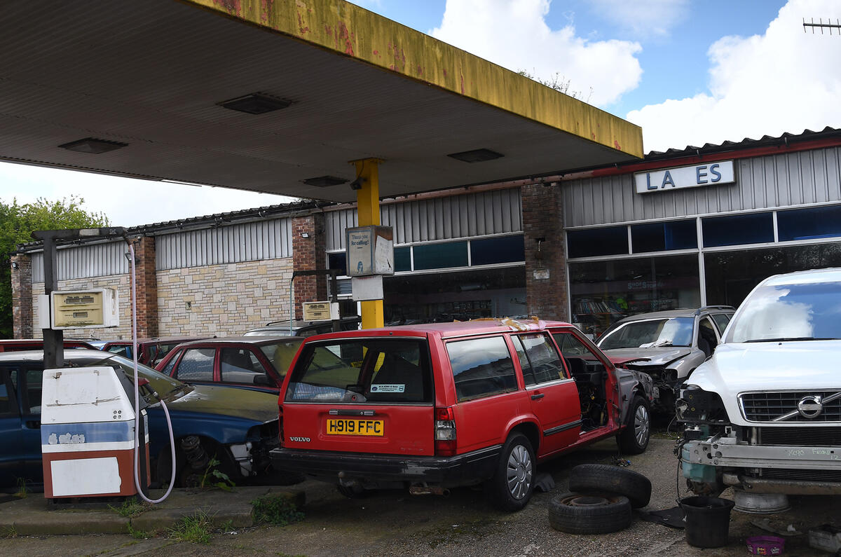 scrapped volvos under a petrol garage