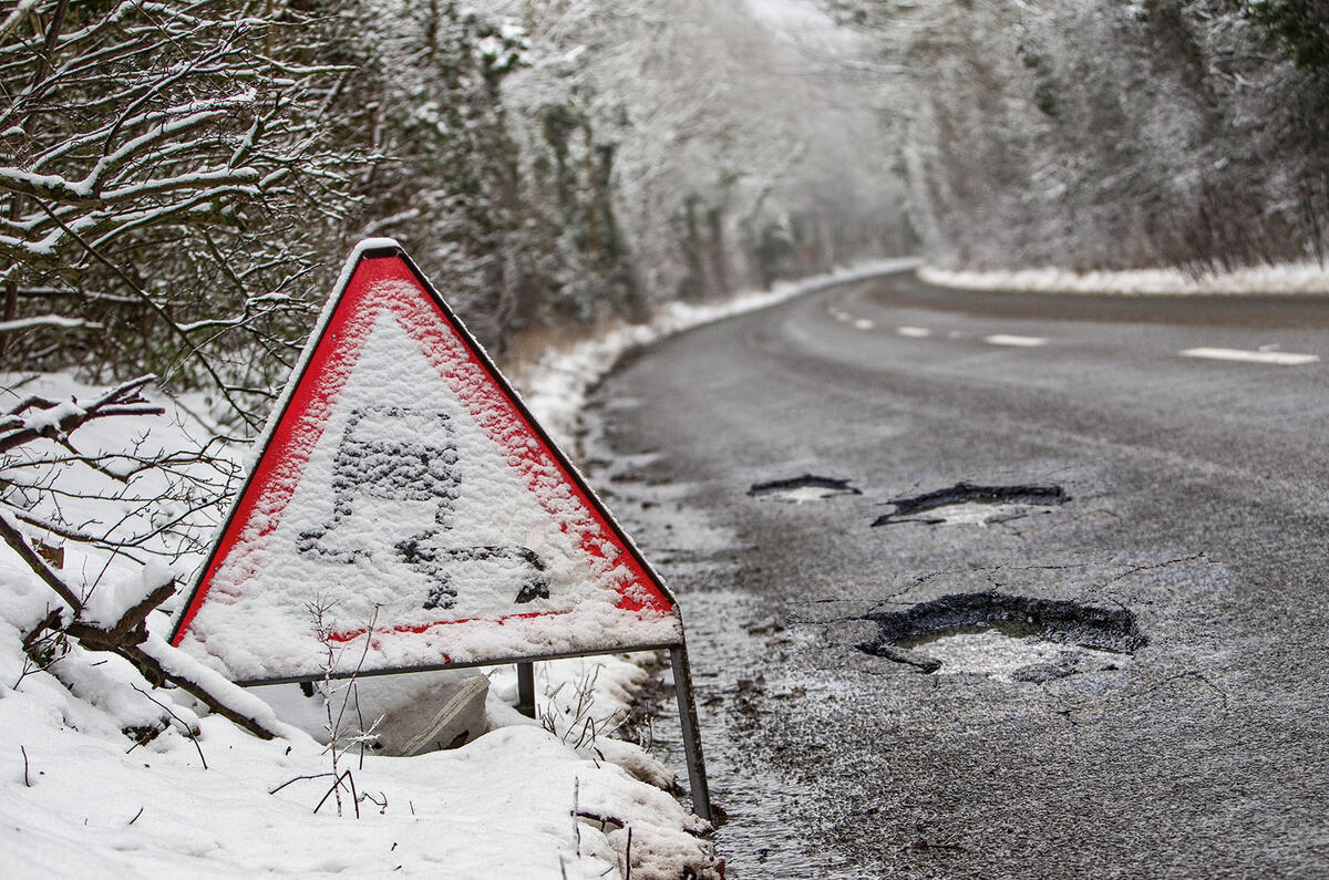 Snowy road with pothole Snowy road with pothole