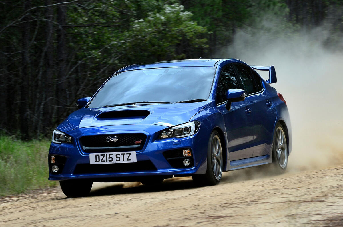 Subaru WRX STi on dirt front quarter tracking