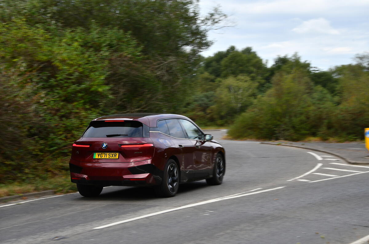 BMW iX at speed rear BMW iX at speed rear