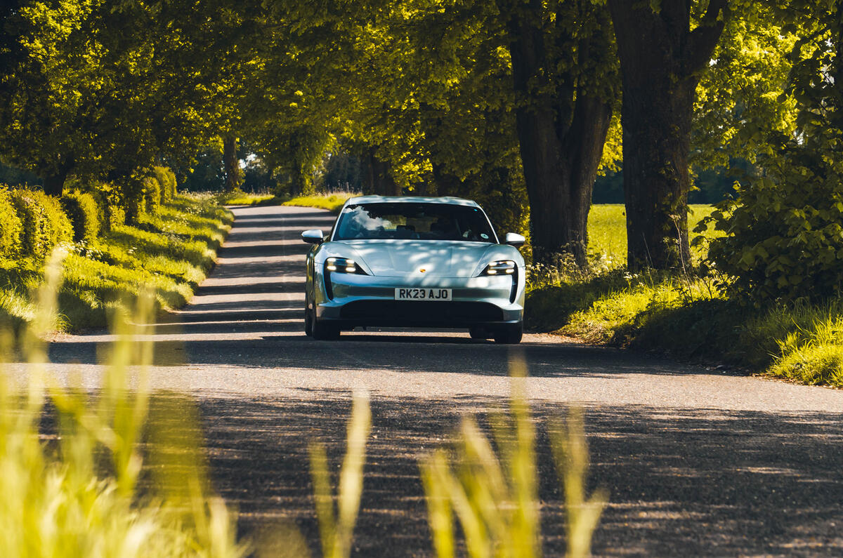 Porsche Taycan driving through trees