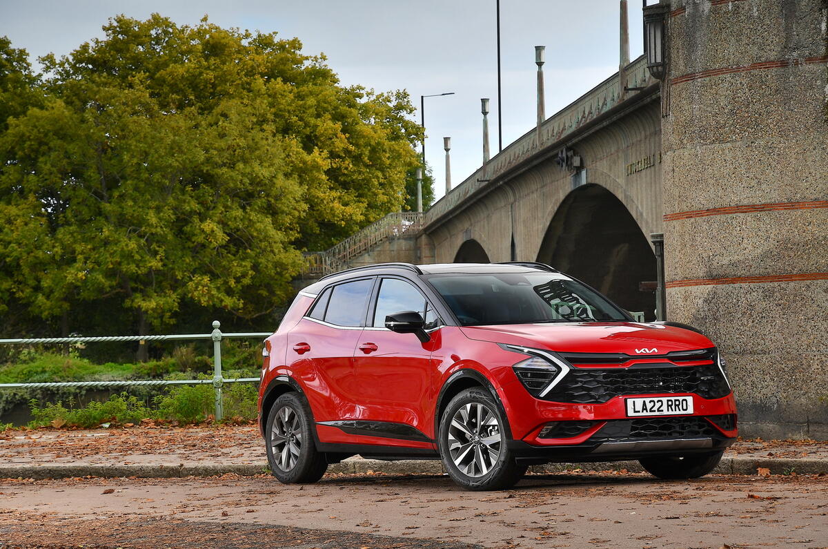 Red Kia Sportage under a bridge Red Kia Sportage under a bridge
