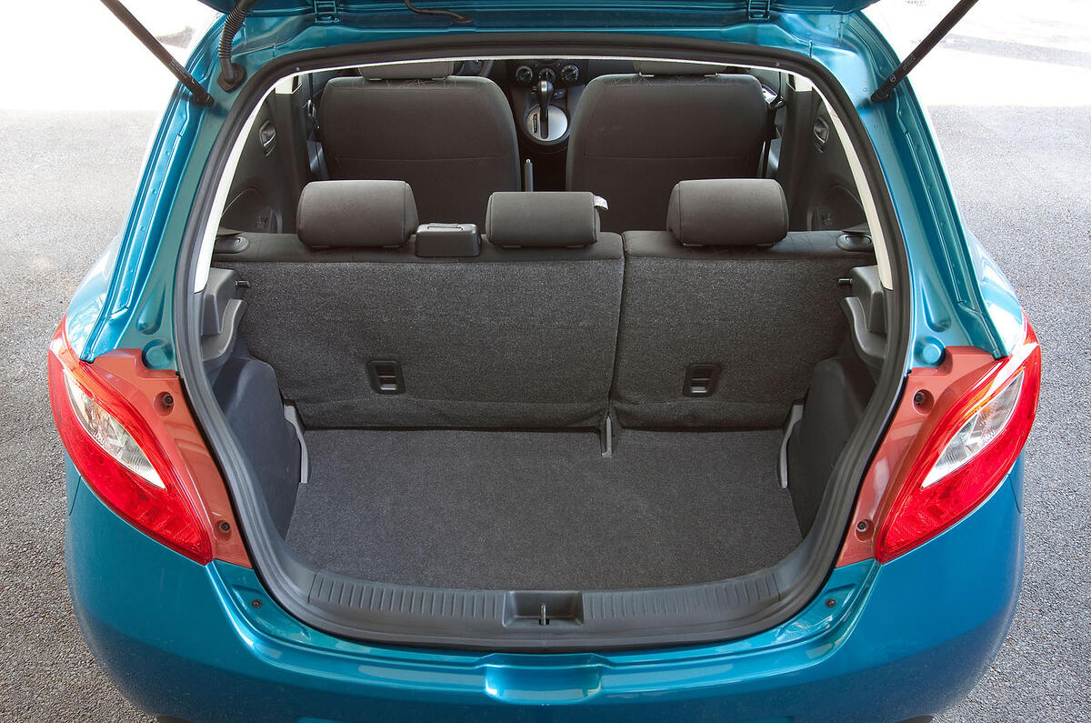 The rear seats don't fold completely flat, but there's a removable, suspended floor Mazda 2