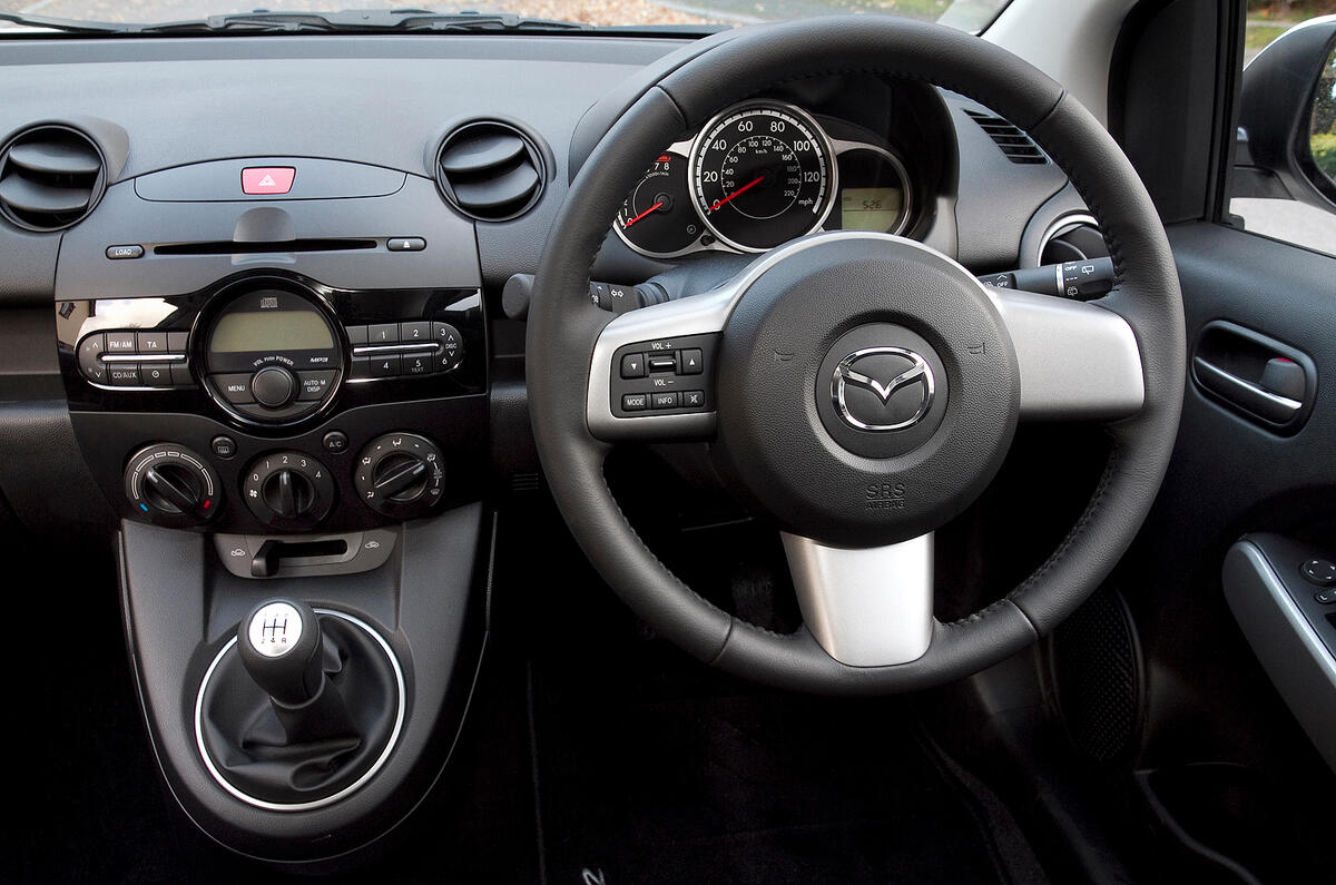The gearstick is mounted high, and is well positioned to operate Mazda 2