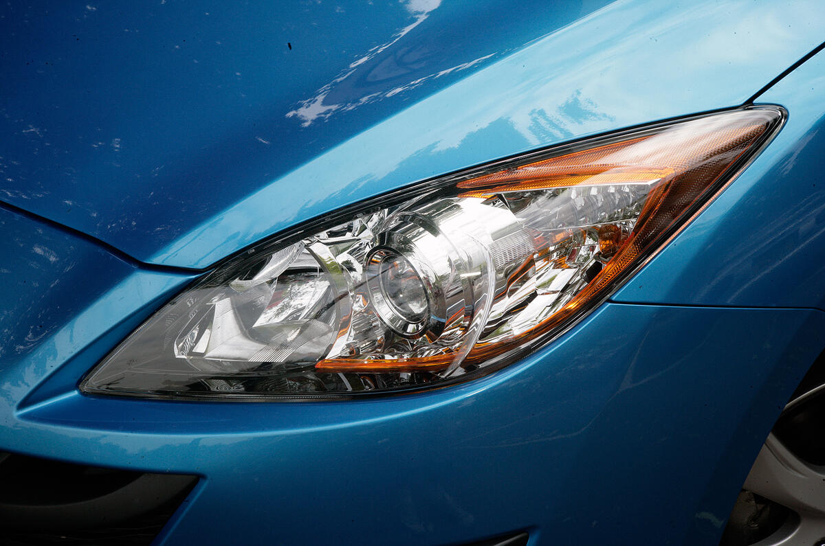 Headlights look overdone. Oddly the amber strip is not the indicator; there is an exposed amber bulb for that Mazda 3 xenon headlights