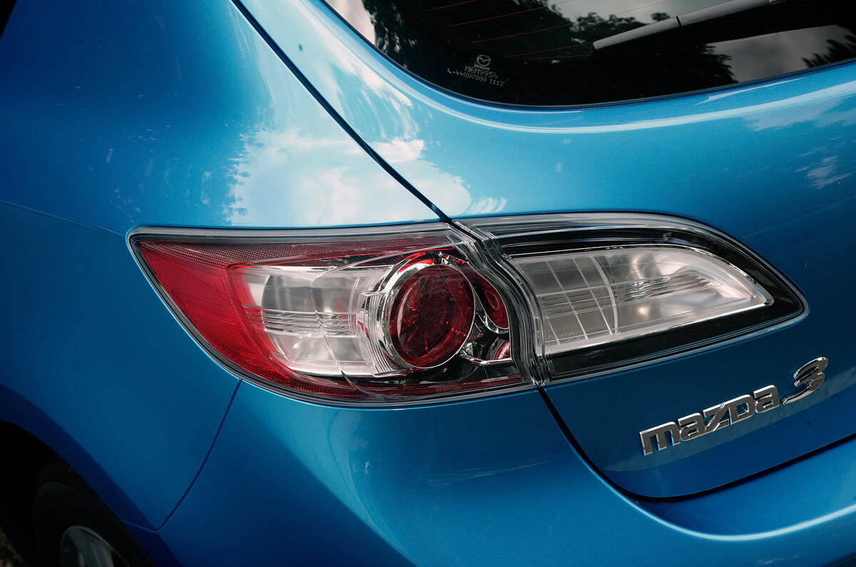 Tail-lights look like something from an accessory shop, with their clear lenses, glinting circles within and the splashes of red Mazda 3 rear lights