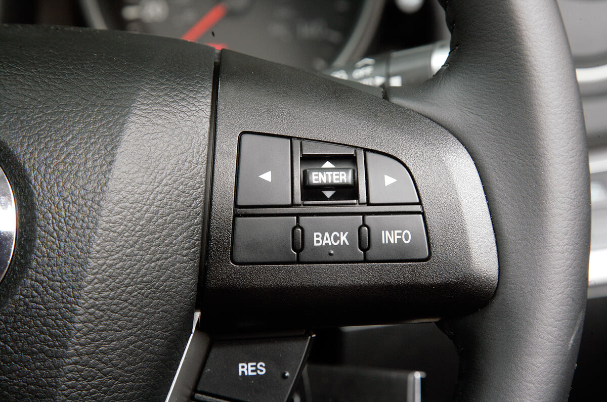 The steering wheel features a leather rim  as well as controls for the stereo, cruise control, trip computer and phone Mazda 3 steering wheel buttons