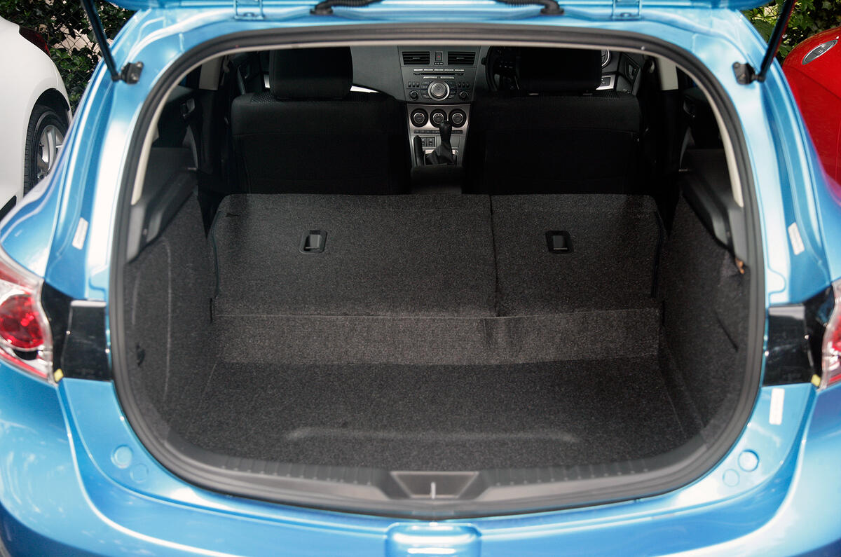Large boot has a high sill. The boot mat is backed in cheap corrugated plastic Mazda 3 boot space