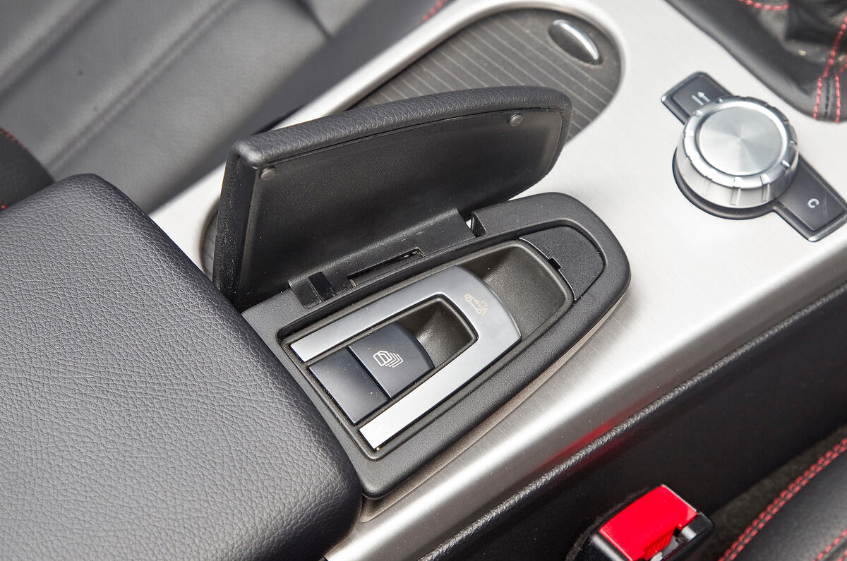 The button to operate the roof is hidden beneath a hinged cover on the centre console Mercedes-Benz SLK roof control button